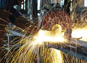 Vibrant sparks fly during welding in a busy workshop, showcasing intense craftsmanship.